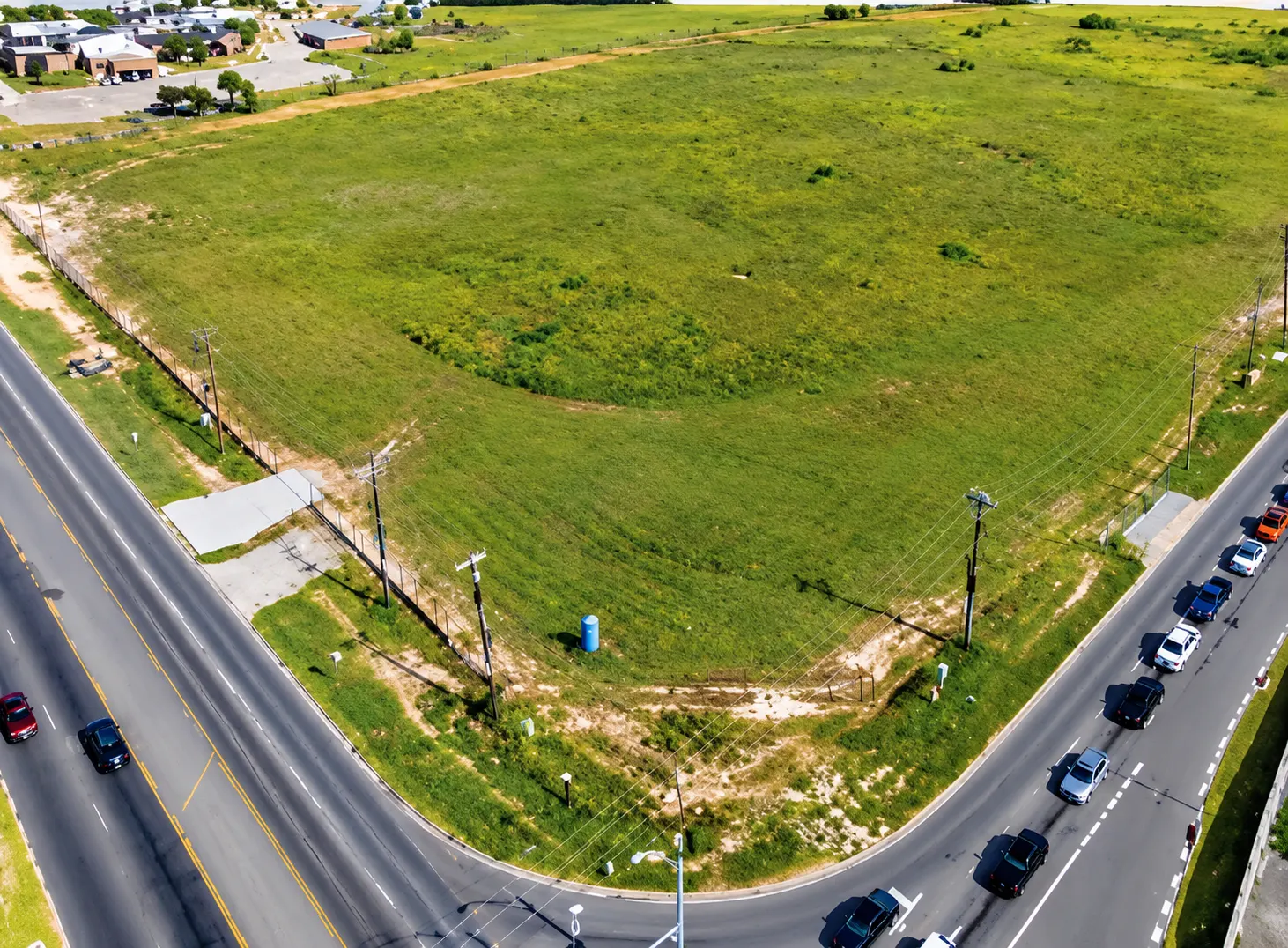 Aerial View of Vacant Green Corner Lot